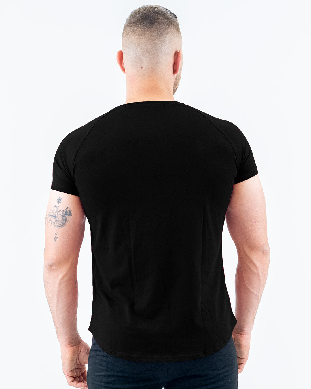 Mighty Black Fit T-Shirt on model, fitted arms, relaxed midsection